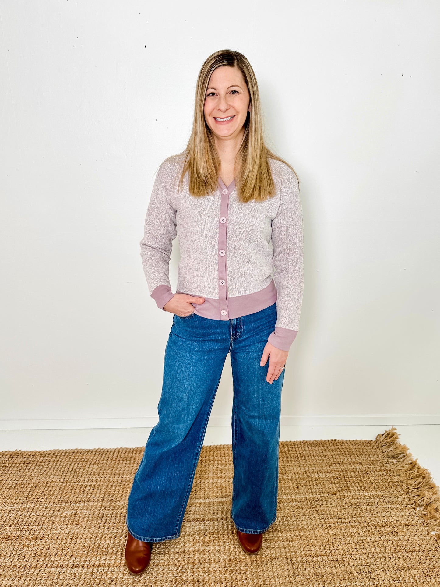 Women's button-front cardigan in lightweight knit fleece cotton blend, available in heathered lavender. Features matching ribbed trims, classic fit, drop-shoulder long sleeves, banded hem & cuffs, and matching buttons. Light-medium weight fabric with slight stretch. Versatile styling. Available in XS-3X.