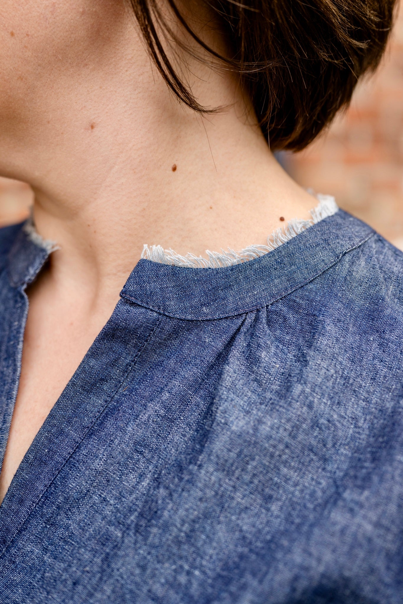 Elbow sleeve with frayed collar