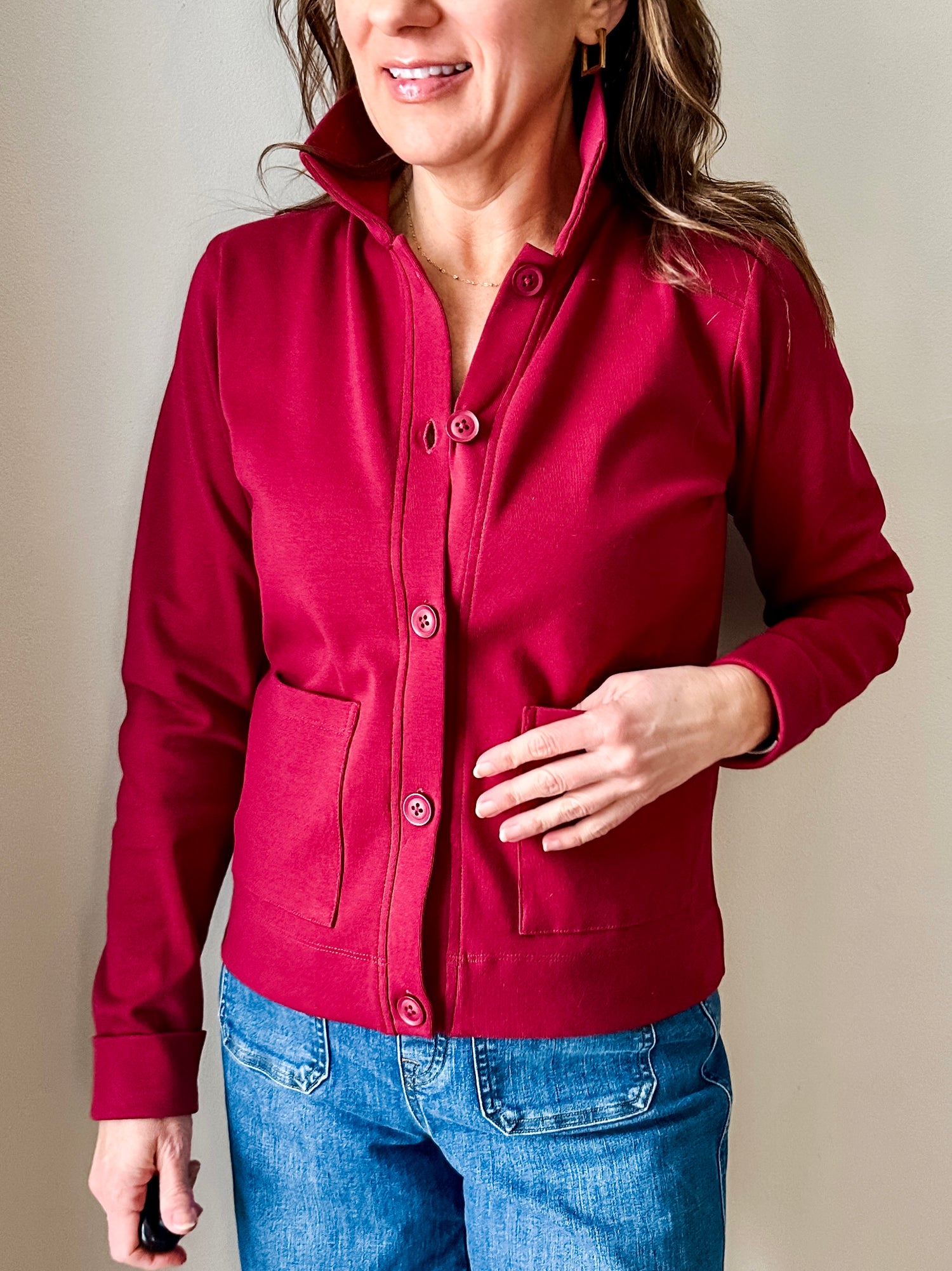 Versatile women's jacket with front pockets and a slightly boxy fit, crafted from soft 100% cotton surplus knit ribbed fabric. Features revised lower chest pockets, matching front buttons, and a stylish shirt collar. Medium-weight design hits at the waist or slightly below for a flattering fit.