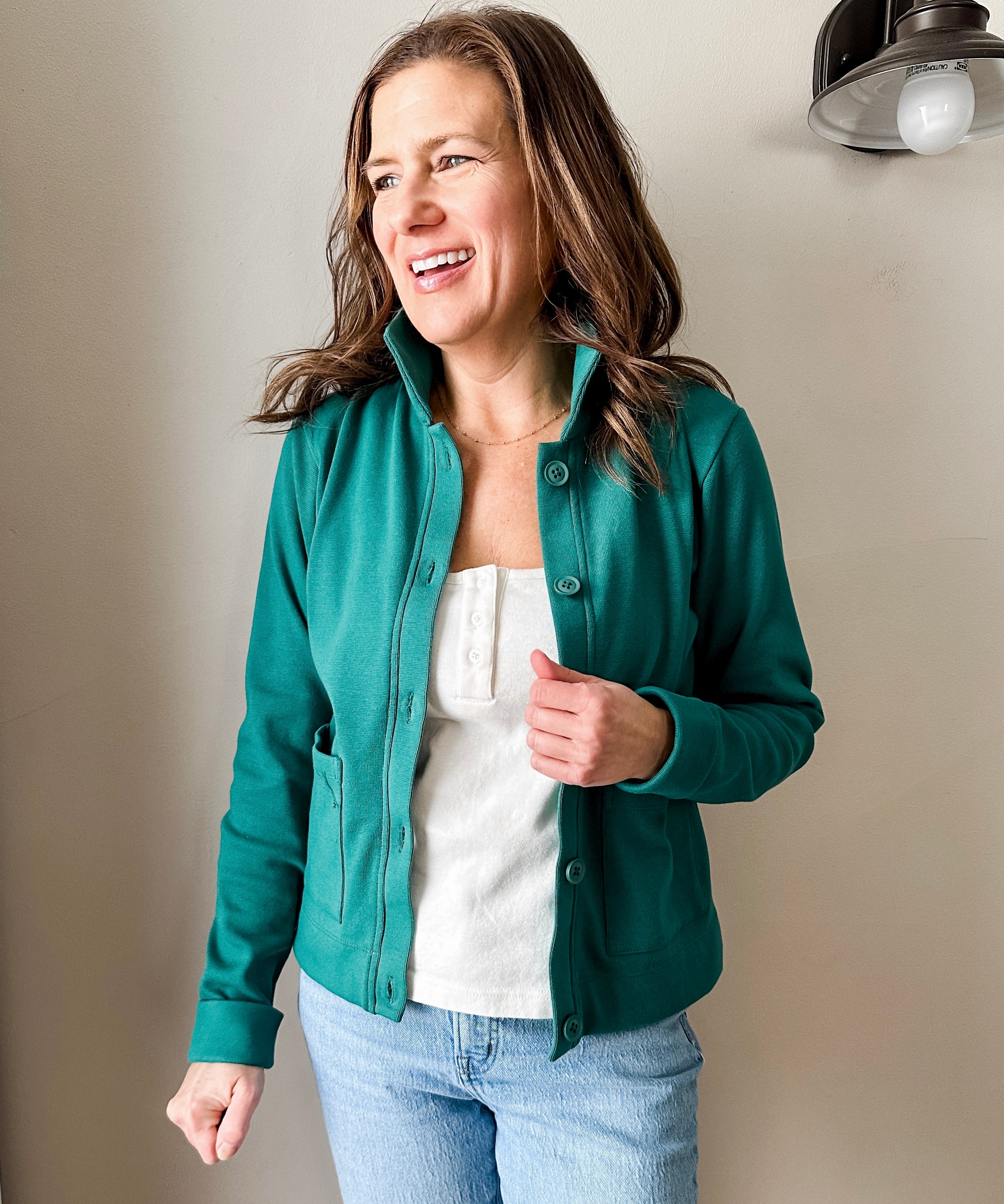 Versatile women's jacket with front pockets and a slightly boxy fit, crafted from soft 100% cotton surplus knit ribbed fabric. Features revised lower chest pockets, matching front buttons, and a stylish shirt collar. Medium-weight design hits at the waist or slightly below for a flattering fit.