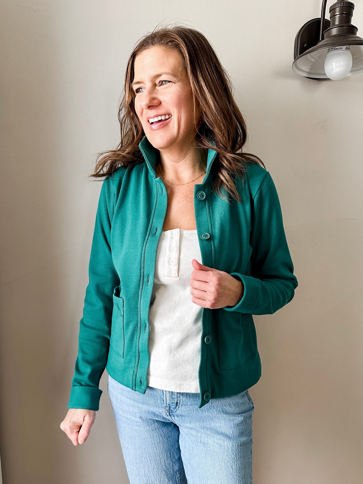 Versatile women's jacket with front pockets and a slightly boxy fit, crafted from soft 100% cotton surplus knit ribbed fabric. Features revised lower chest pockets, matching front buttons, and a stylish shirt collar. Medium-weight design hits at the waist or slightly below for a flattering fit.