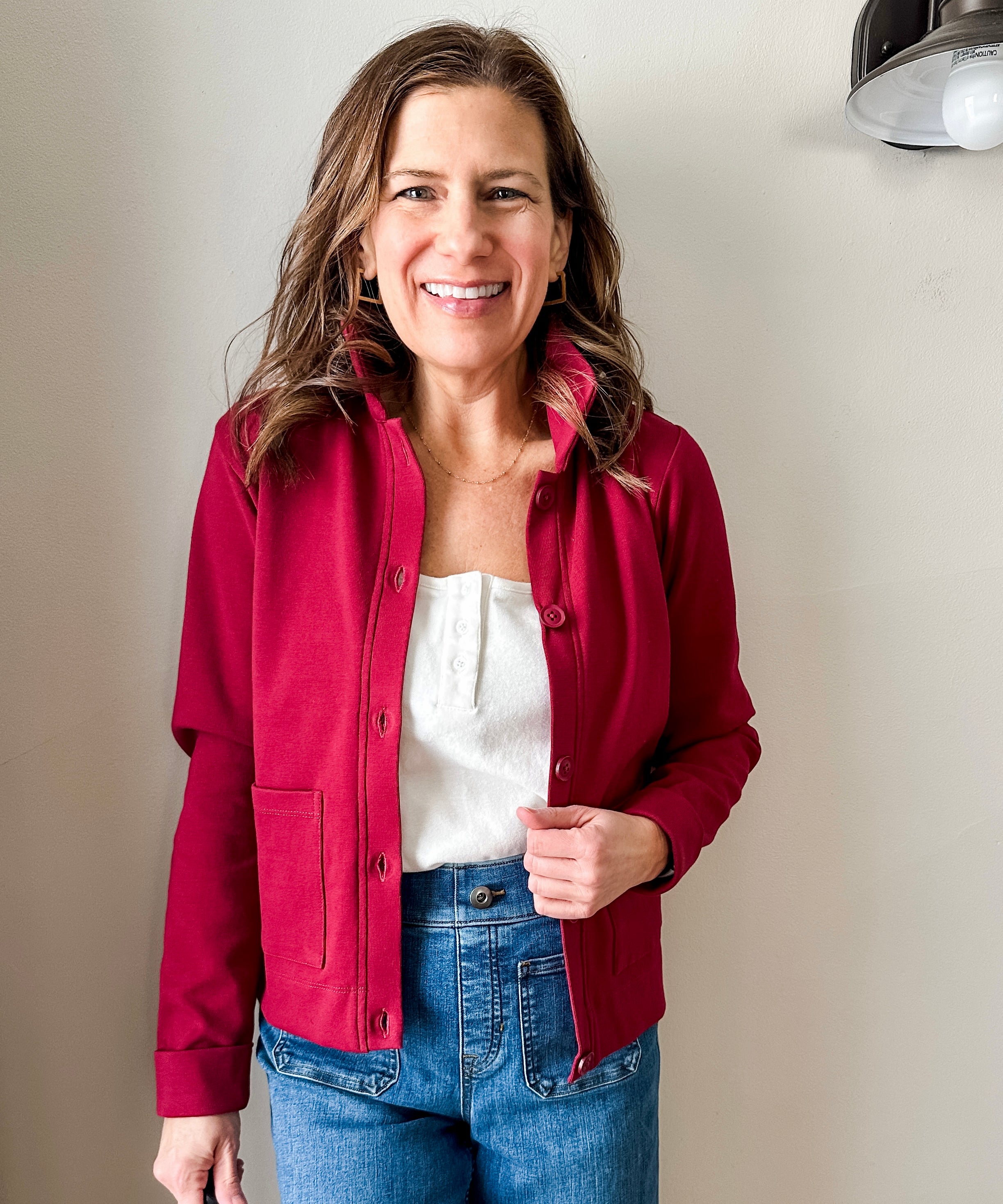 Versatile women's jacket with front pockets and a slightly boxy fit, crafted from soft 100% cotton surplus knit ribbed fabric. Features revised lower chest pockets, matching front buttons, and a stylish shirt collar. Medium-weight design hits at the waist or slightly below for a flattering fit.