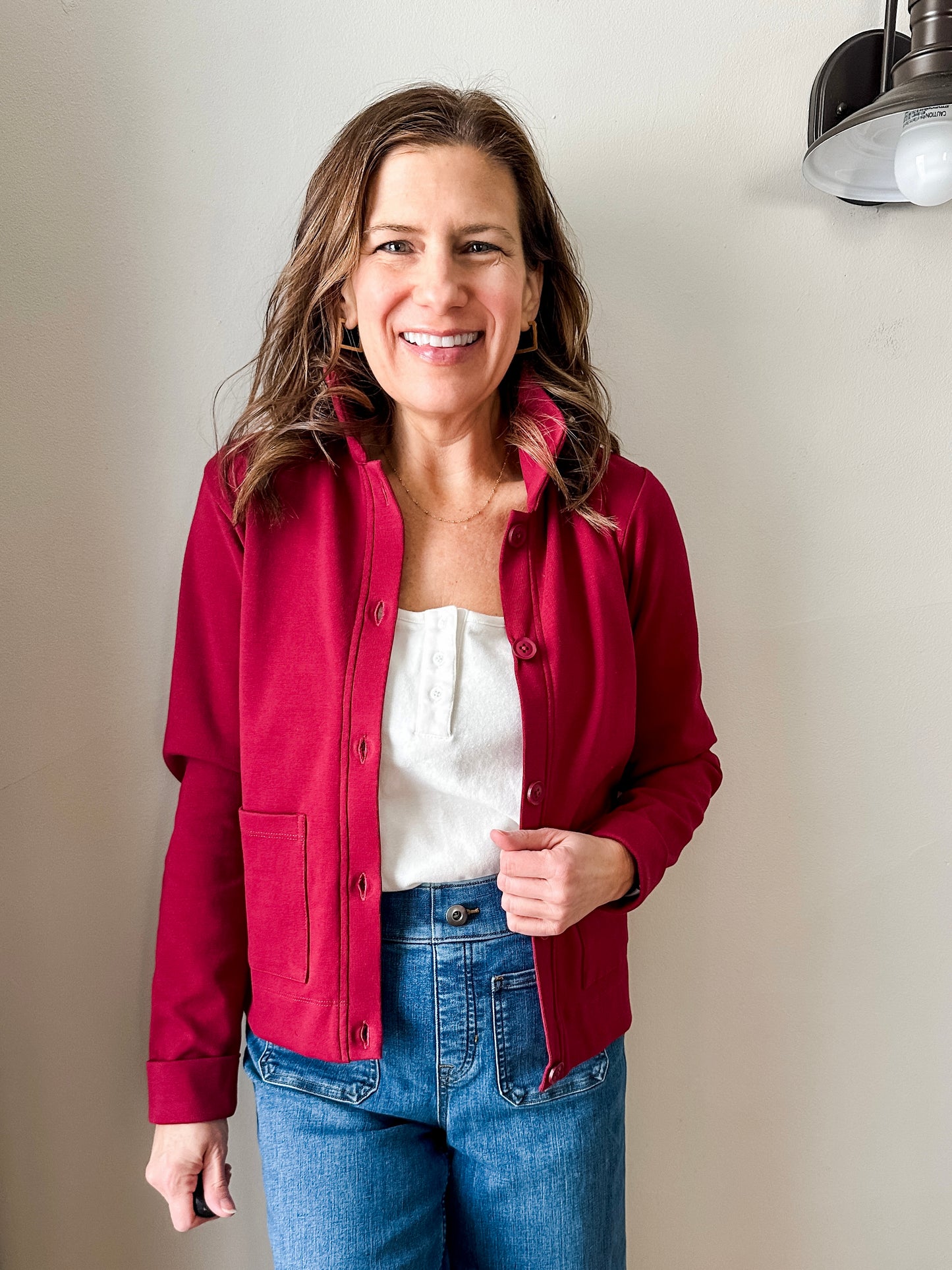 Versatile women's jacket with front pockets and a slightly boxy fit, crafted from soft 100% cotton surplus knit ribbed fabric. Features revised lower chest pockets, matching front buttons, and a stylish shirt collar. Medium-weight design hits at the waist or slightly below for a flattering fit.