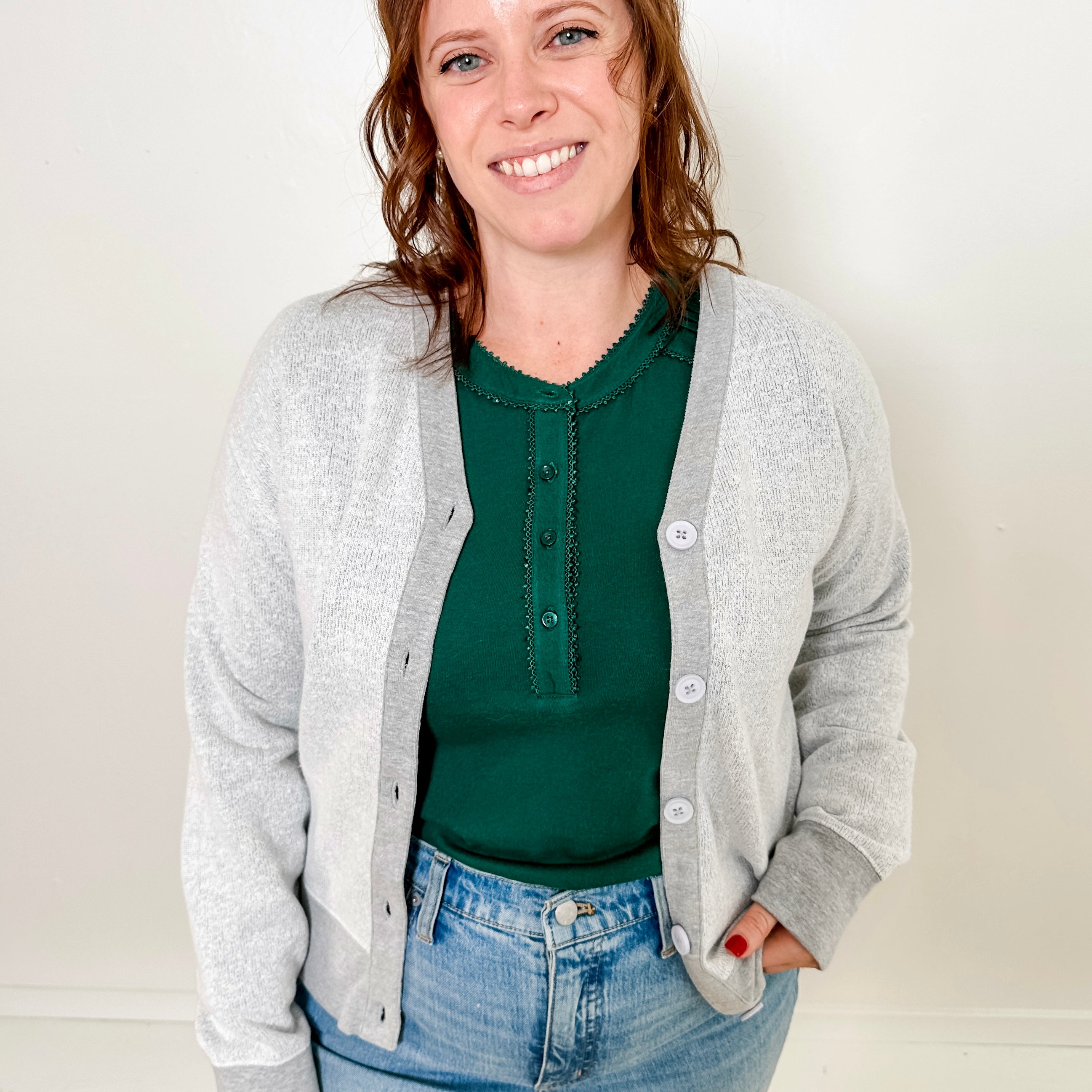 Women's button-front cardigan in lightweight knit fleece cotton blend, available in light grey. Features matching ribbed trims, classic fit, drop-shoulder long sleeves, banded hem & cuffs, and matching buttons. Light-medium weight fabric with slight stretch. Versatile styling. Available in XS-3X.