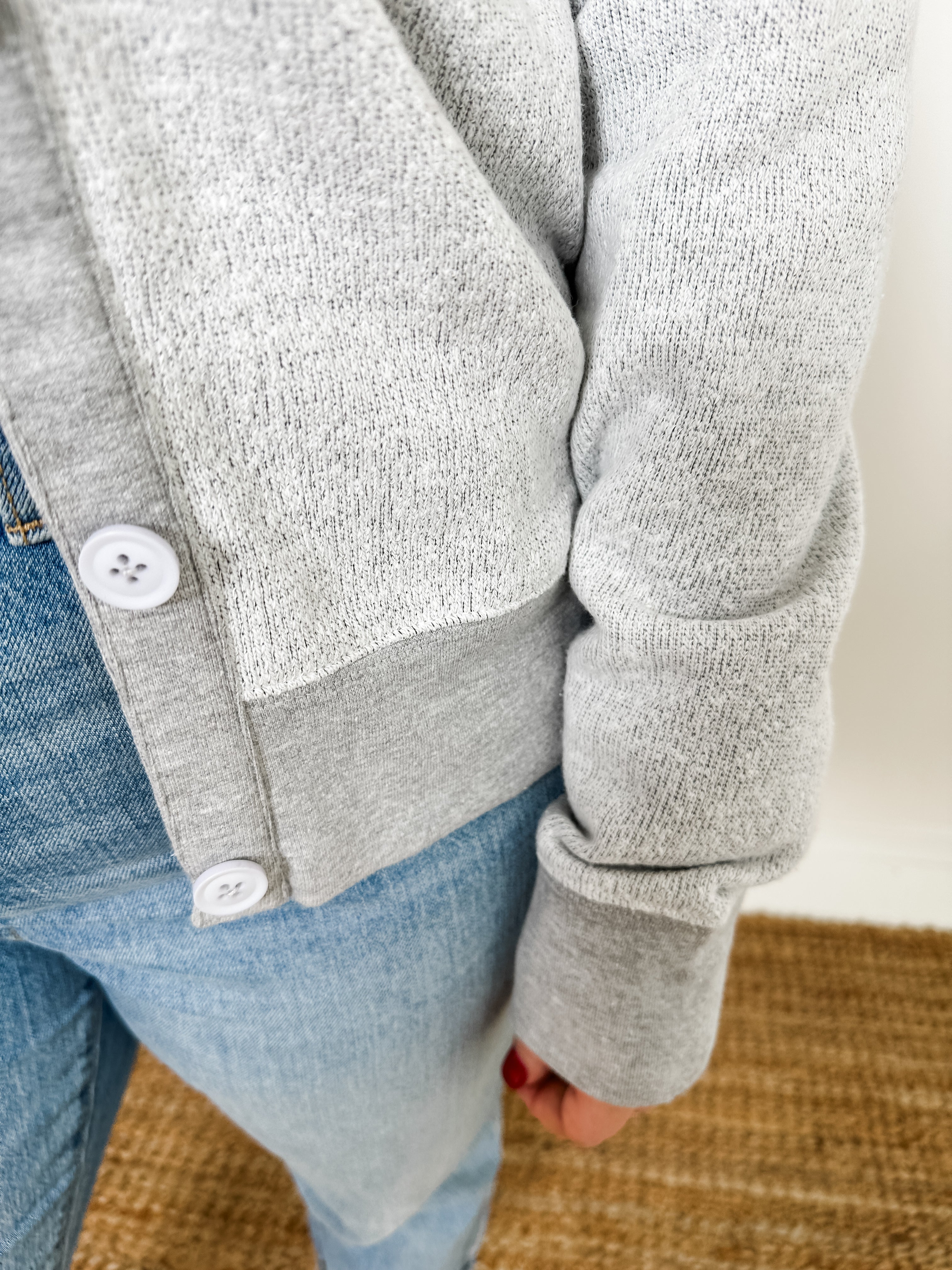 Women's button-front cardigan in lightweight knit fleece cotton blend, available in light grey. Features matching ribbed trims, classic fit, drop-shoulder long sleeves, banded hem & cuffs, and matching buttons. Light-medium weight fabric with slight stretch. Versatile styling. Available in XS-3X.