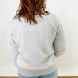 Women's button-front cardigan in lightweight knit fleece cotton blend, available in light grey. Features matching ribbed trims, classic fit, drop-shoulder long sleeves, banded hem & cuffs, and matching buttons. Light-medium weight fabric with slight stretch. Versatile styling. Available in XS-3X.