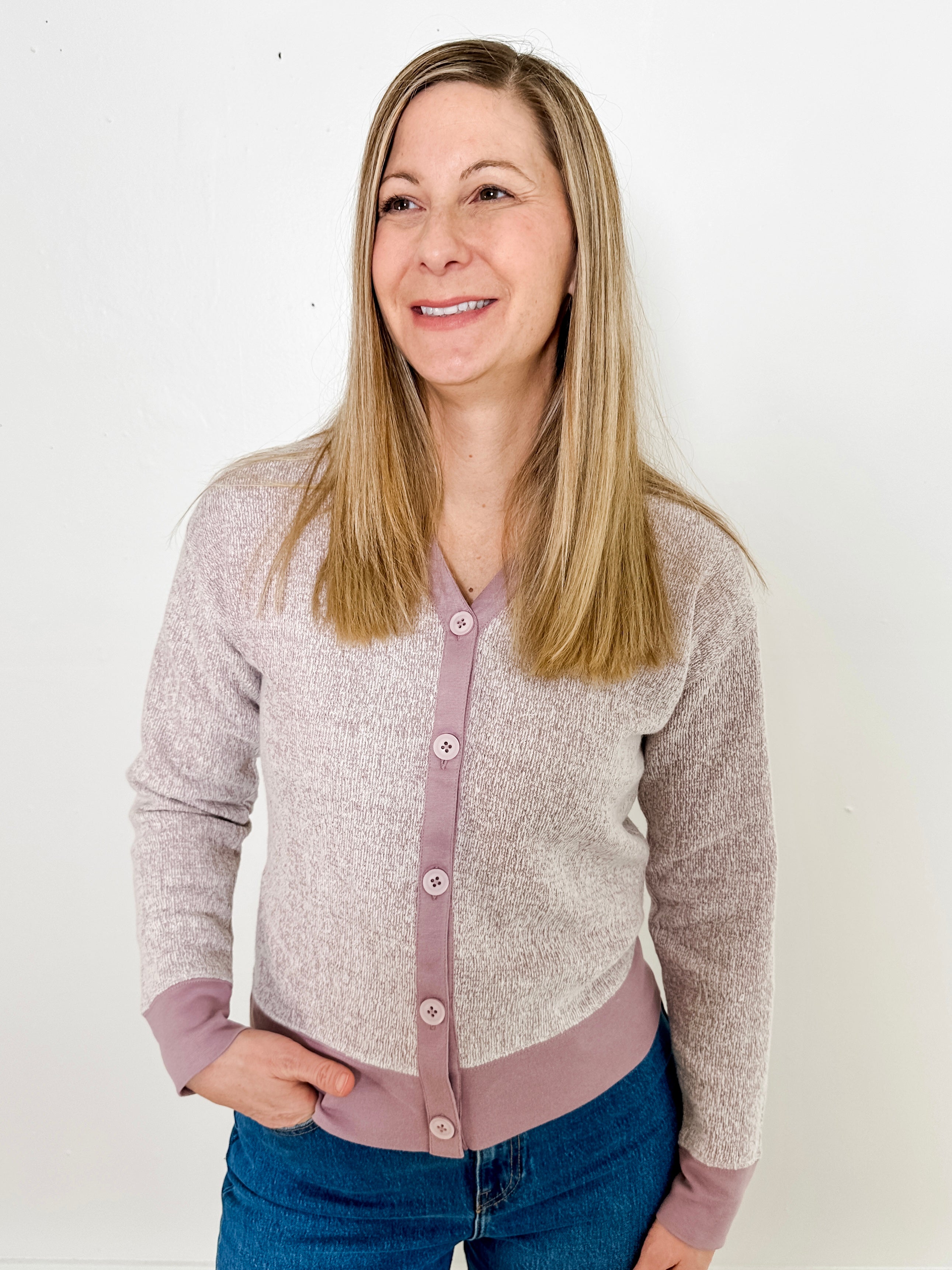 Women's button-front cardigan in lightweight knit fleece cotton blend, available in heathered lavender. Features matching ribbed trims, classic fit, drop-shoulder long sleeves, banded hem & cuffs, and matching buttons. Light-medium weight fabric with slight stretch. Versatile styling. Available in XS-3X.