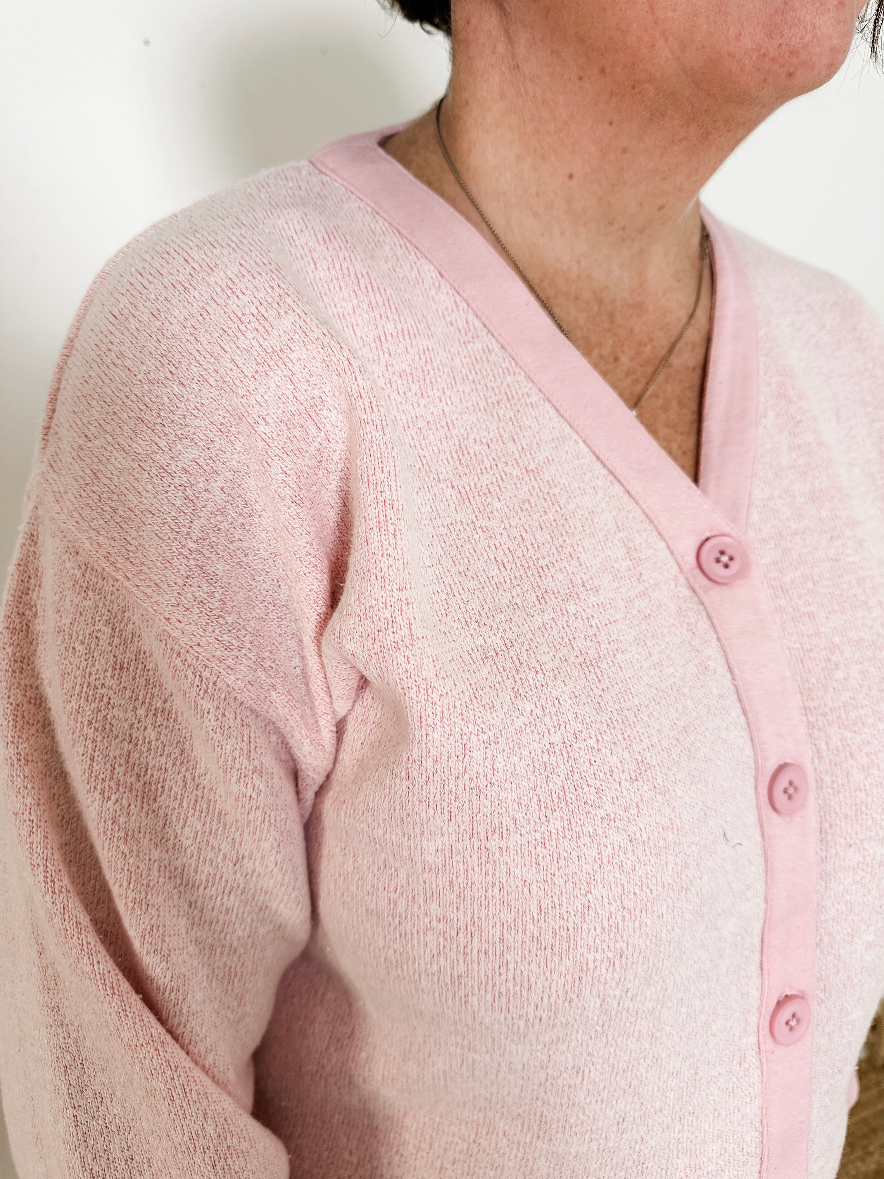 Women's button-front cardigan in lightweight knit fleece cotton blend, available in light pink. Features matching ribbed trims, classic fit, drop-shoulder long sleeves, banded hem & cuffs, and matching buttons. Light-medium weight fabric with slight stretch. Versatile styling. Available in XS-3X.