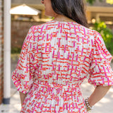 Chic midi dress made from 100% woven viscose surplus fabric, featuring a flattering V-neck with hook-and-eye closures. Designed with a smocked waist for a contoured fit, side slant pockets for convenience, and a pintuck hem between tiers for added texture. Pullover styling with elastic-cuff 3/4 length sleeves, subtle shoulder gathers, and delicate sleeve detailing. A versatile and breathable dress perfect for effortless style.