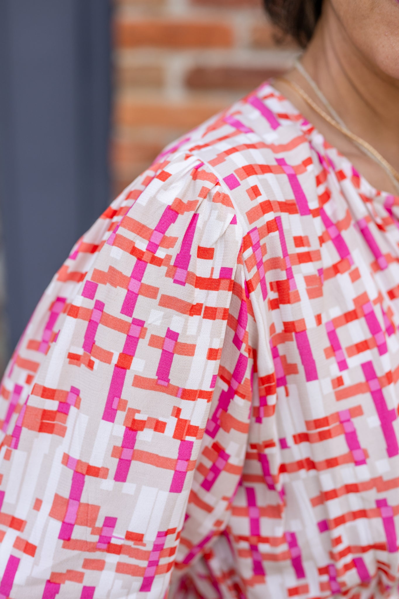 Chic midi dress made from 100% woven viscose surplus fabric, featuring a flattering V-neck with hook-and-eye closures. Designed with a smocked waist for a contoured fit, side slant pockets for convenience, and a pintuck hem between tiers for added texture. Pullover styling with elastic-cuff 3/4 length sleeves, subtle shoulder gathers, and delicate sleeve detailing. A versatile and breathable dress perfect for effortless style.